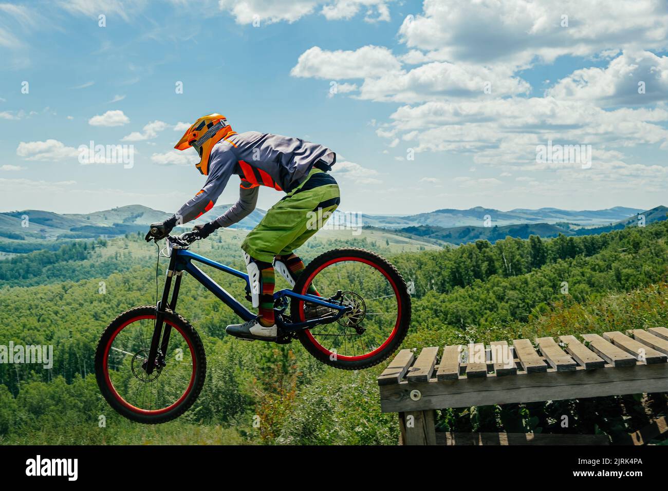 athlete rider drops downhill jump Stock Photo
