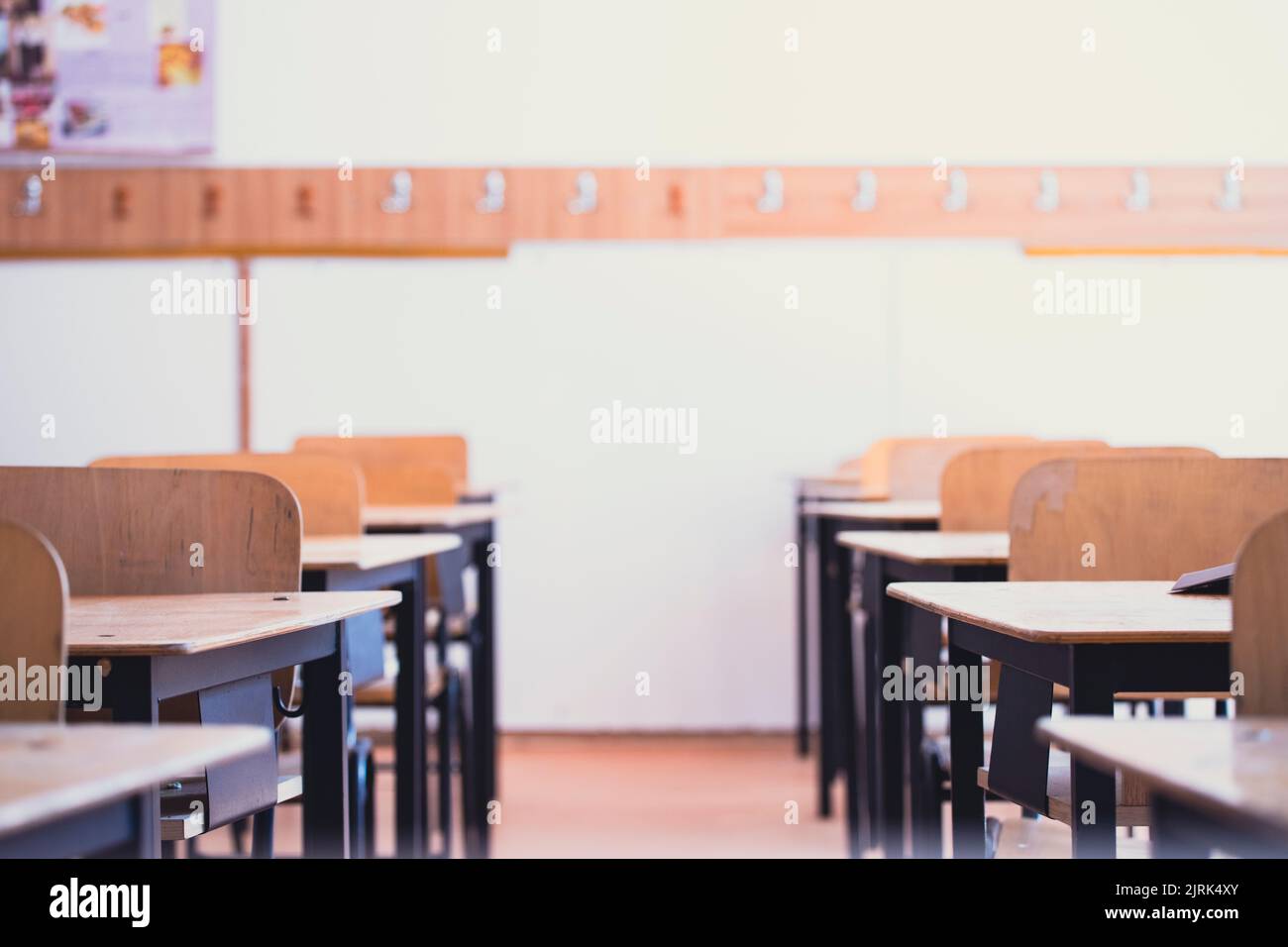 Back to School Concept. Empty classroom with chairs, desks and chalkboard. Stock Photo