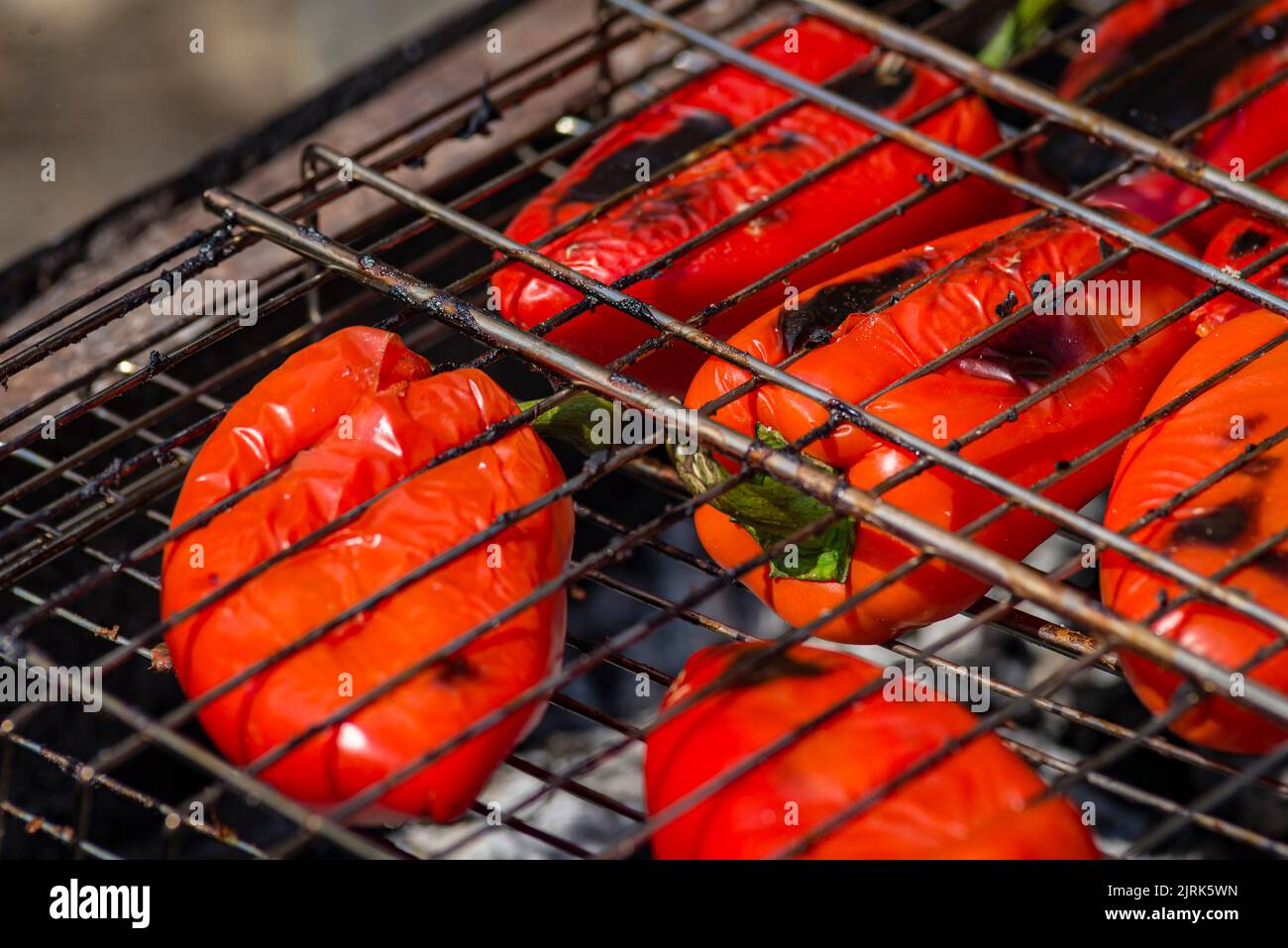 Grilling Process of preparing red bell pepper on barbecue bbq grill