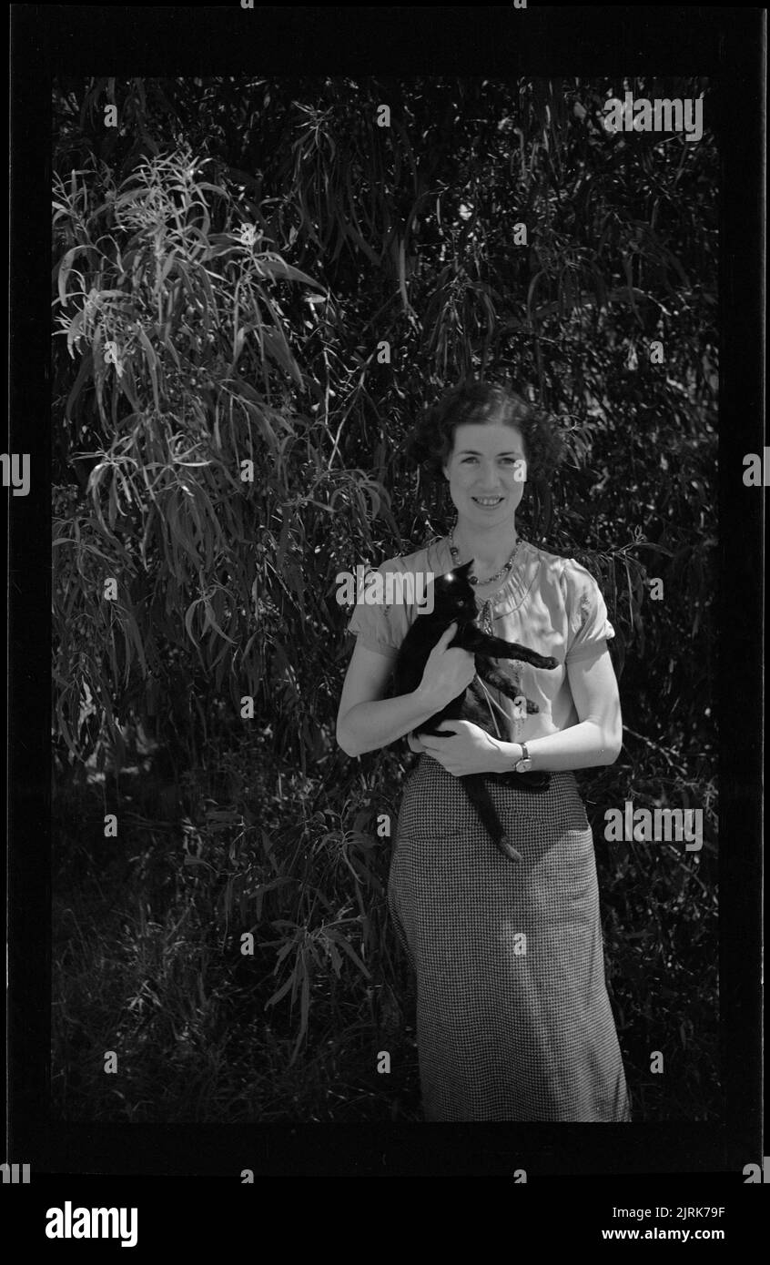 Nurse with cat under gum tree, New Zealand, by J.W. ChapmanTaylor