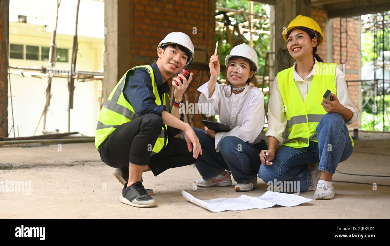 Civil engineers team wearing safety helmets and vests inspecting