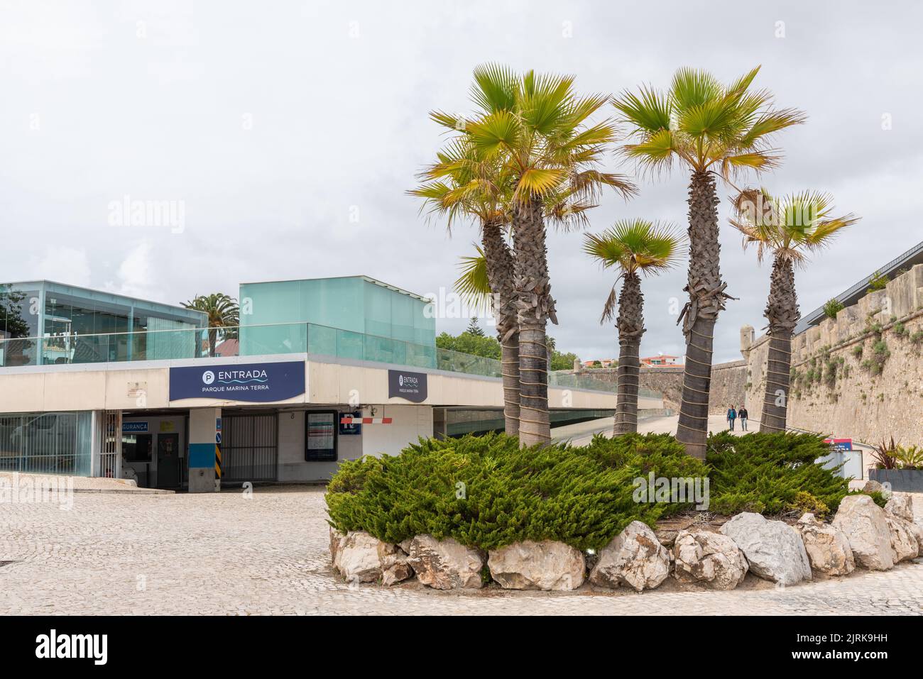 A view of the palms and a two-store underground car park in the background in Cascais, Portugal. Stock Photo