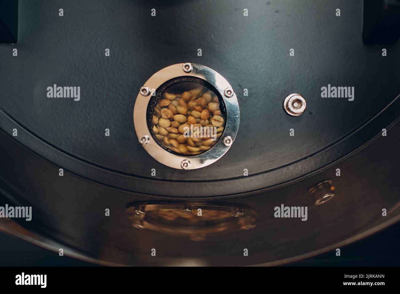 Coffee beans in roaster machine at coffee roasting process Stock Photo