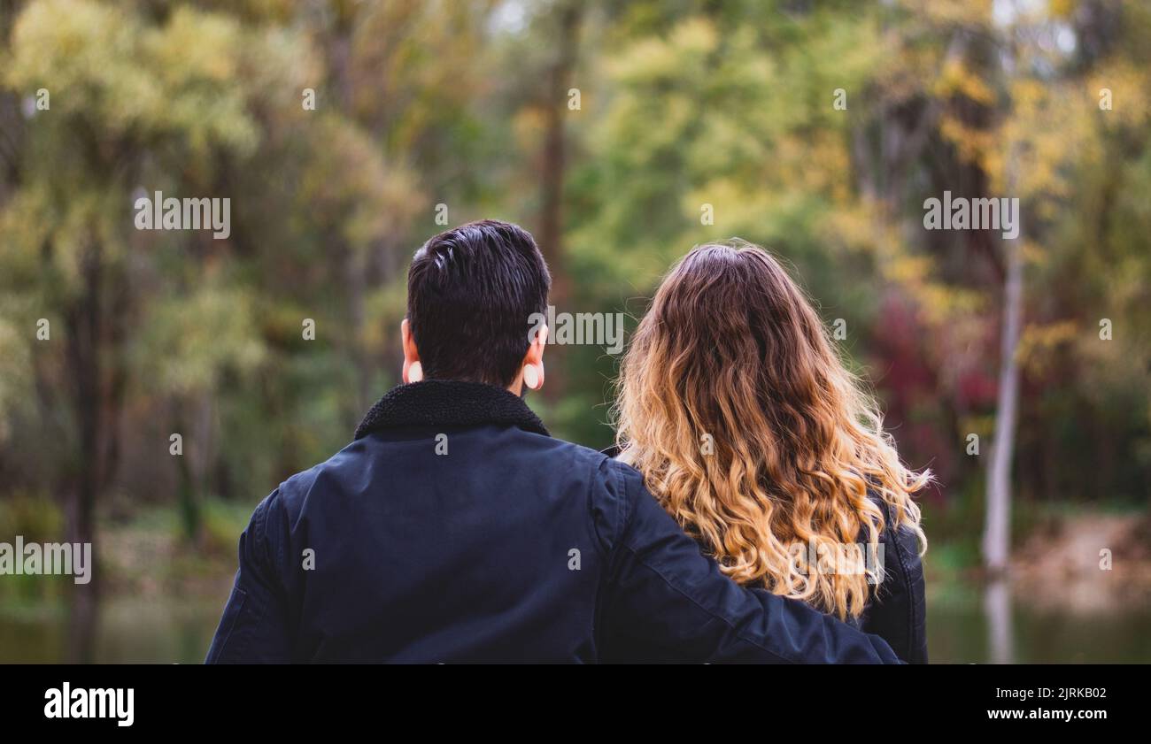 Cute Couple Sitting In The Forest - Relationship Stock Photo - Alamy
