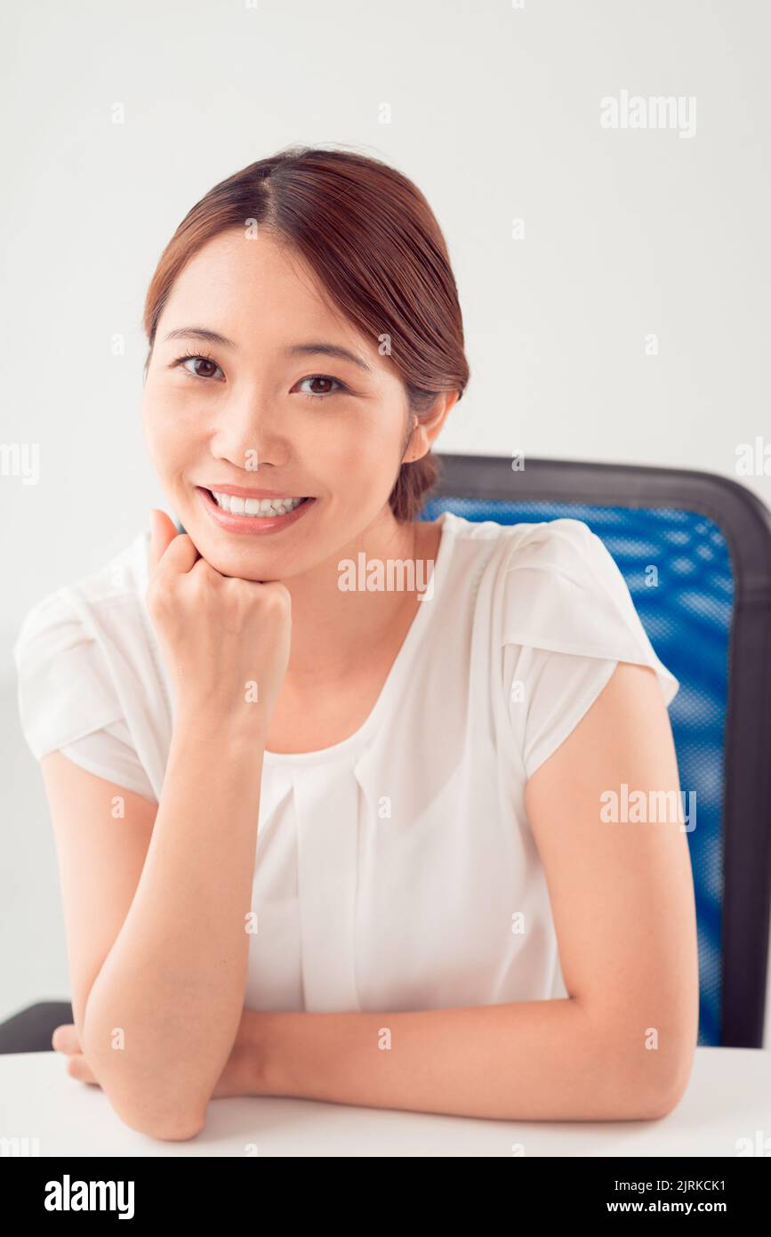 Happy young Japanese business lady at her workplace Stock Photo - Alamy
