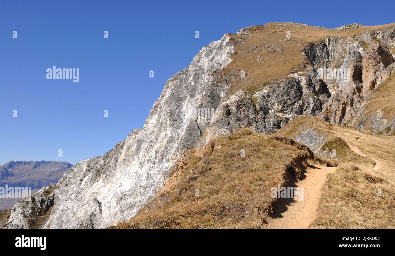 hiking trail in high altitude in the Alps rocky  mountains under clear blue sky Stock Photo