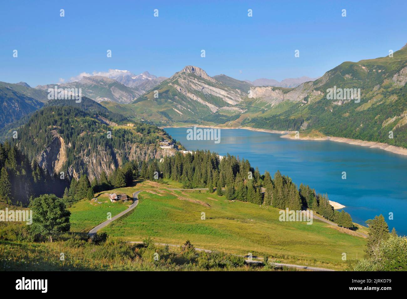 beautiful landscape with a lake and peak montain back and green meadow in the foreground in french Alps Stock Photo