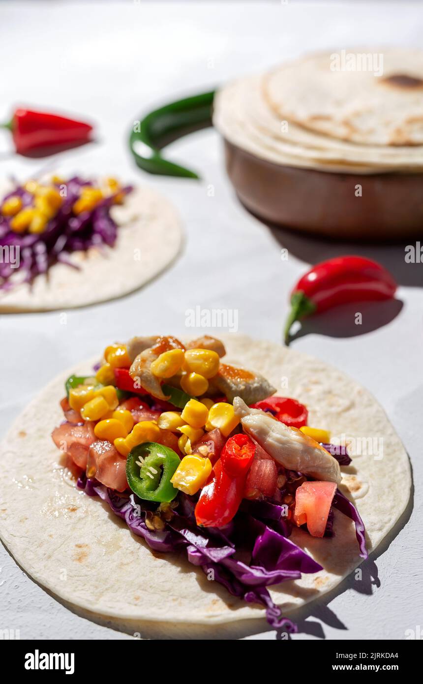 Homemade Mexican Tacos with fresh vegetables and chicken with strong