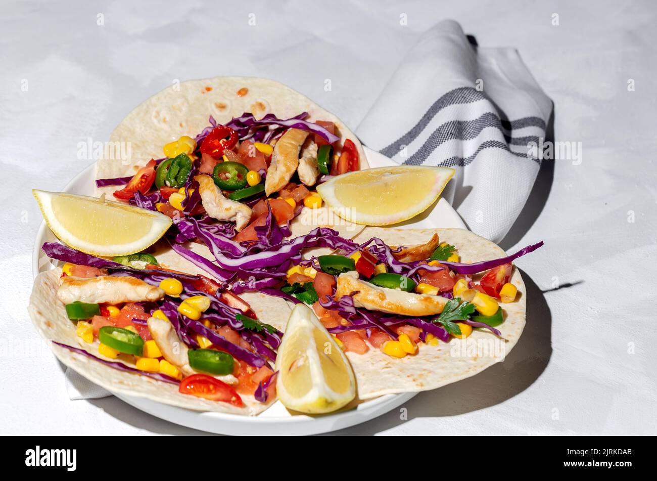 Homemade Mexican Tacos with fresh vegetables and chicken with strong