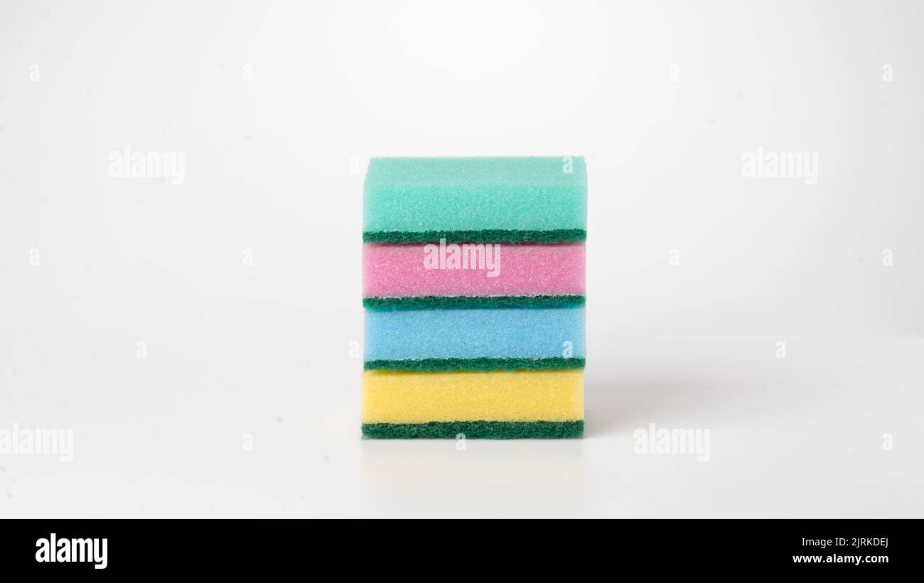Multicolored four sponges folded into a flat stack on a white background. High quality photo Stock Photo