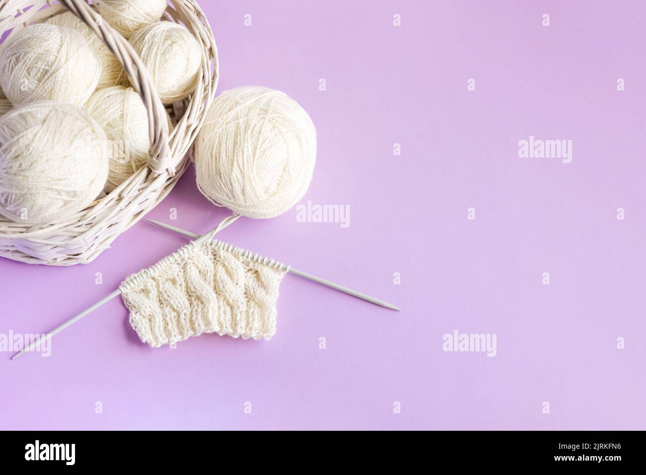 White balls of thread in a basket on a pink background, Hobby Stock Photo