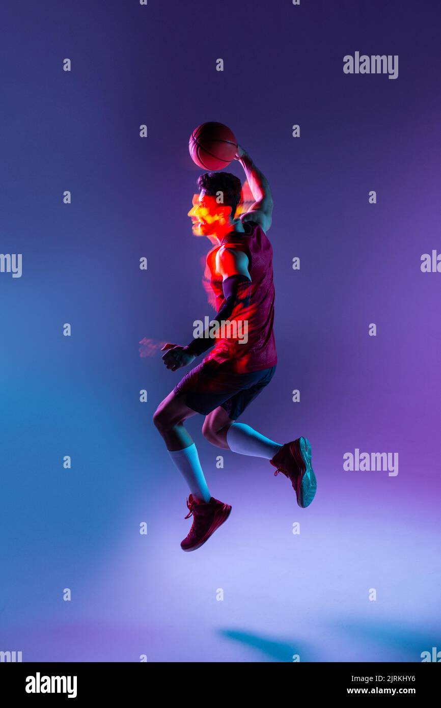Creative studio shot of basketball player in studio using colored gels
