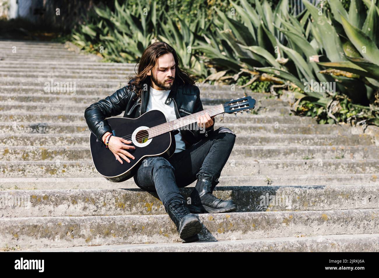 Man playing guitar on stairs hi-res stock photography and images - Alamy