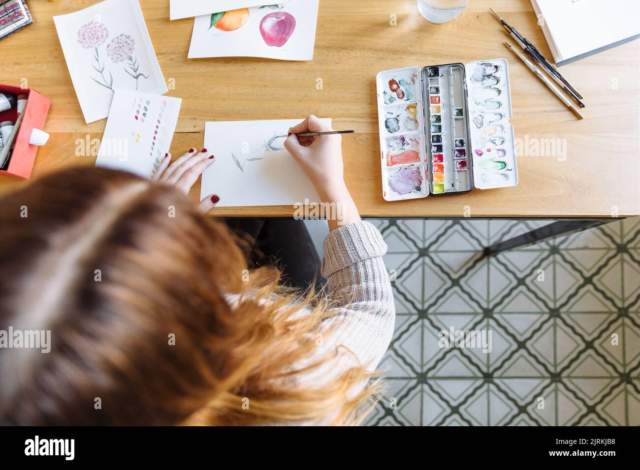 View from above of young girl painting with watercolors Stock Photo - Alamy