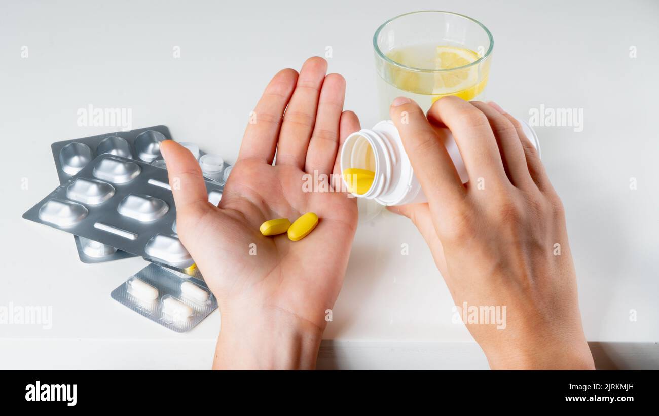 A sick person pours pills from a jar medicine treatment. High quality photo Stock Photo