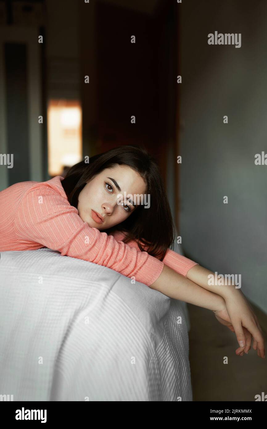 Side view on smart tranquil woman with folded hands propping up head