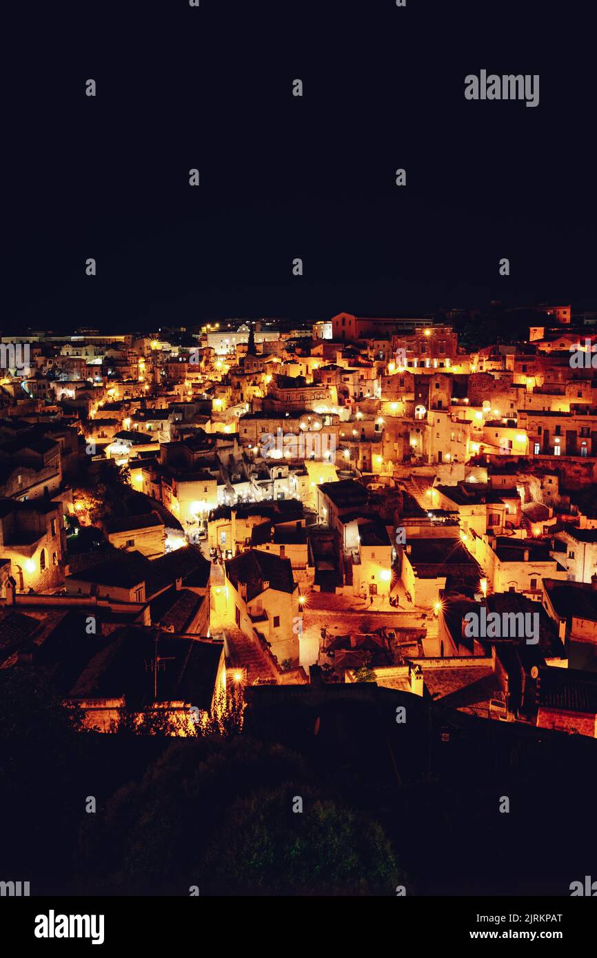 A vertical shot of modern buildings during dark night Stock Photo - Alamy
