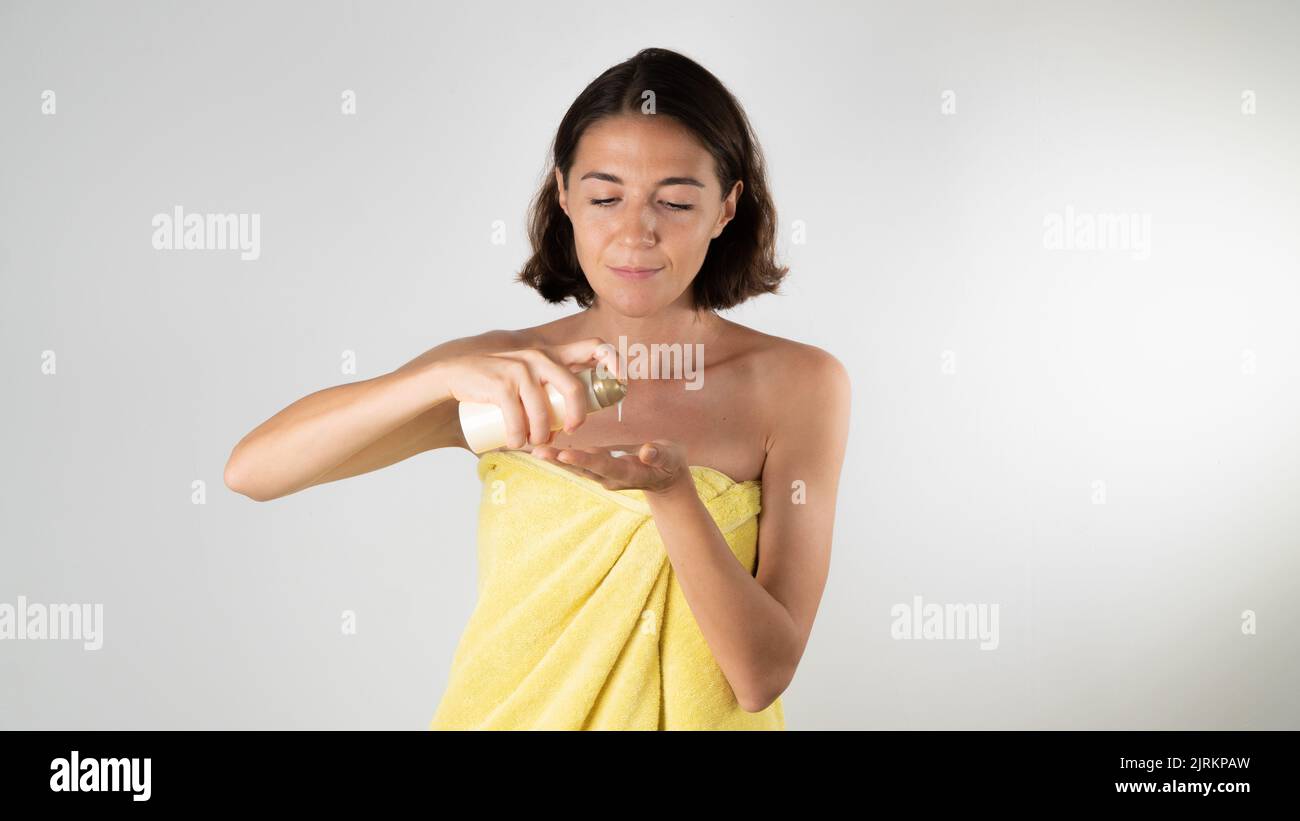 Self-care at home - a woman squeezes the cream on the palm of her hand. High quality photo Stock Photo