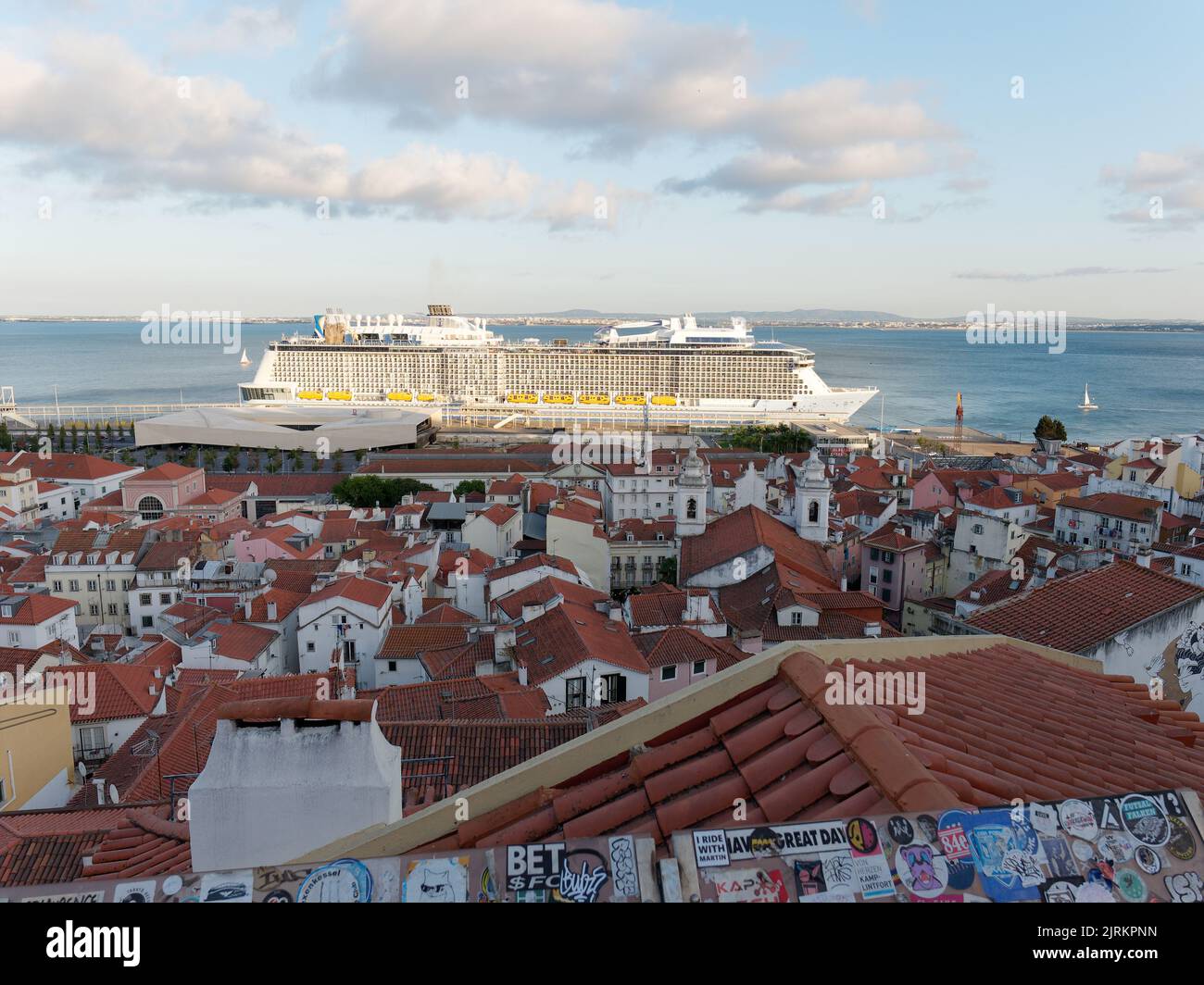 View from Viewpoint Miradouro de Santa Luzia in Lisbon Portugal on a summers evening, with a cruise ship on the River Tagus Stock Photo