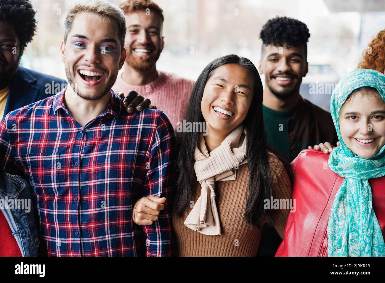 Young diverse people having fun outdoor laughing together - Focus on ...