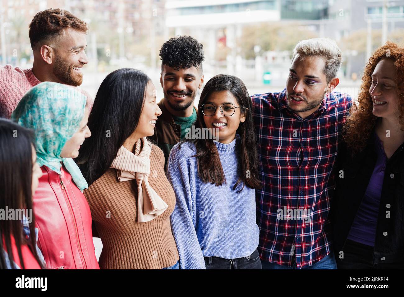 Young diverse people having fun outdoor laughing together - Focus on ...