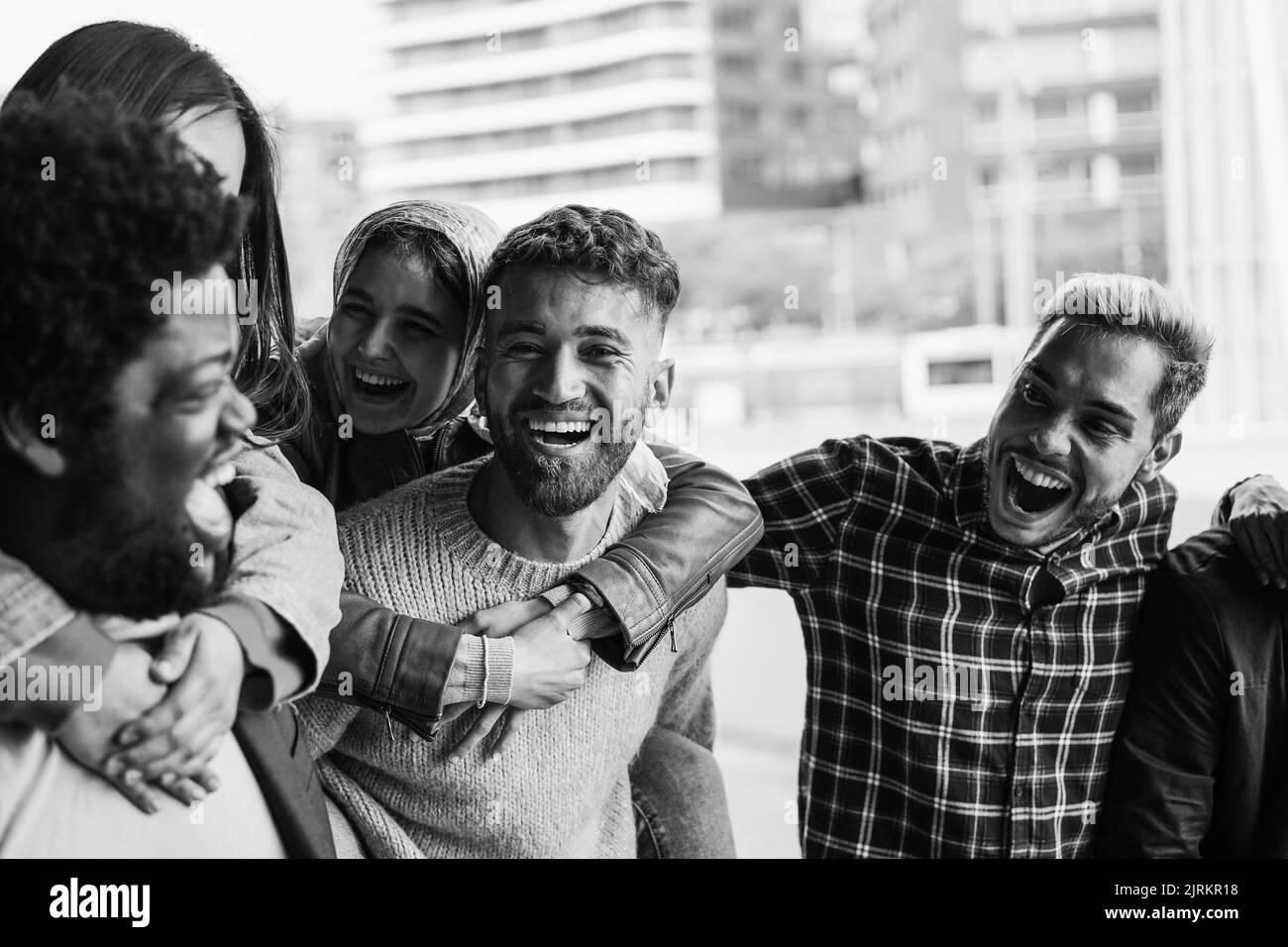 Young diverse people having fun outdoor laughing together - Focus on ...