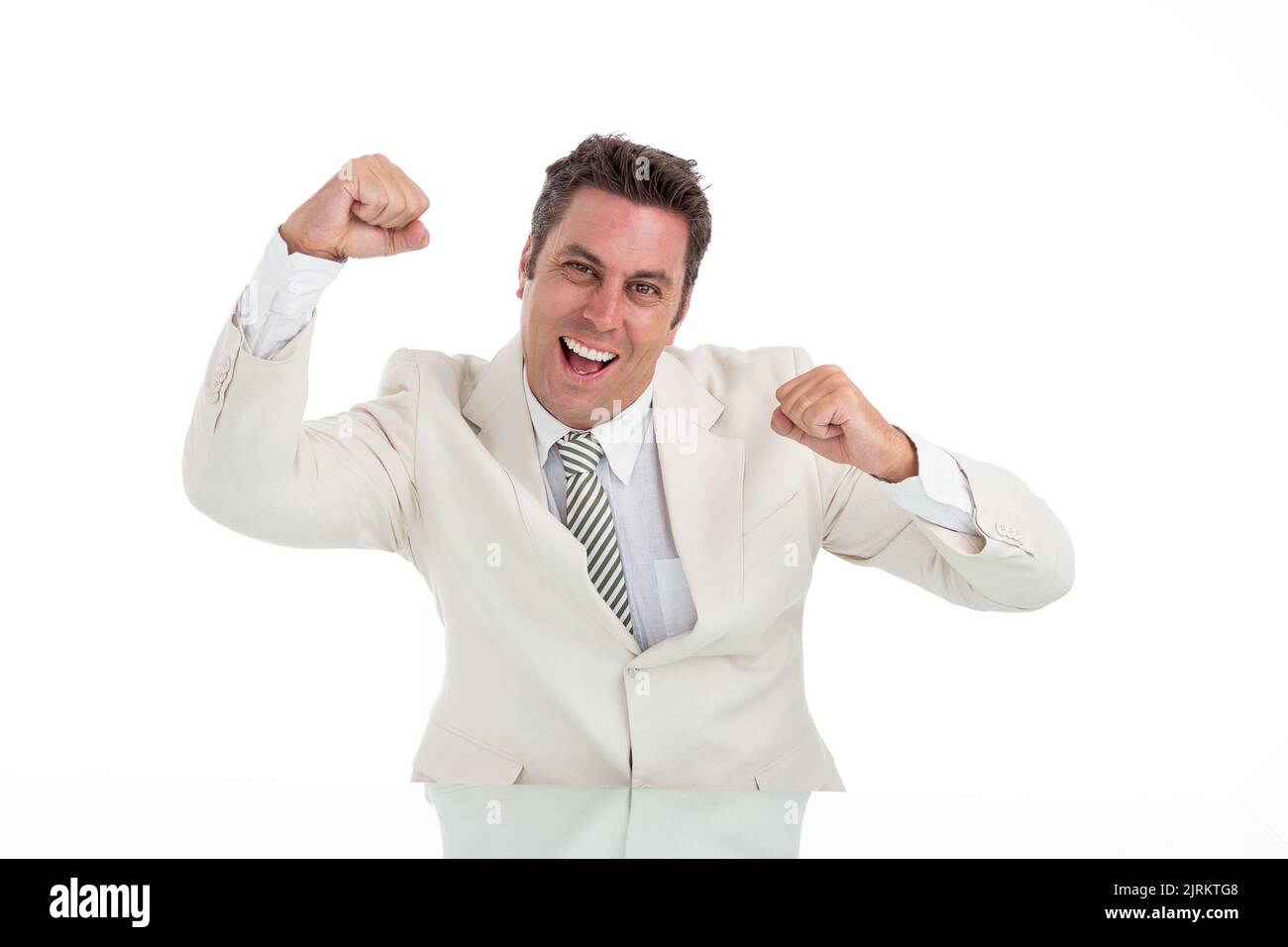 Studio shot of dancing happy businessman in white suit Stock Photo
