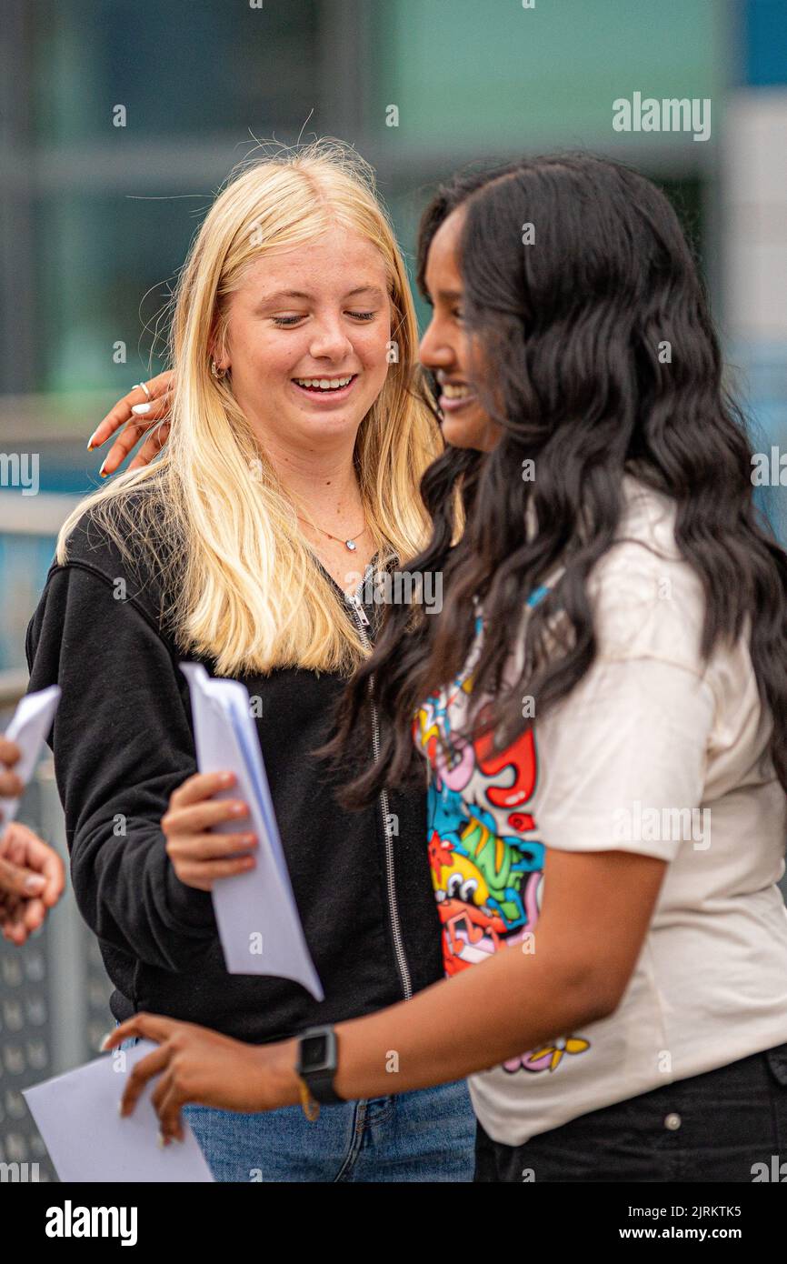 Abigail Woodworth, 16, left, and Anna Raveendran, 16, hug each other