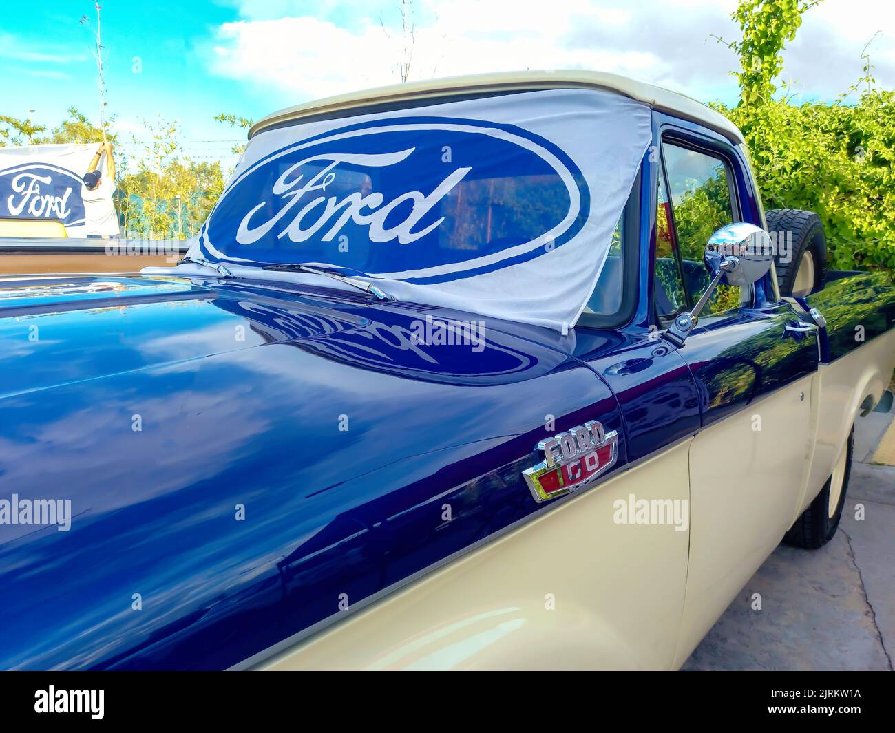 Ford blue oval logo and brand on the windshield of an old F100 V8 utility pickup truck 1963. Expo Fierros 2022 classic car show Stock Photo