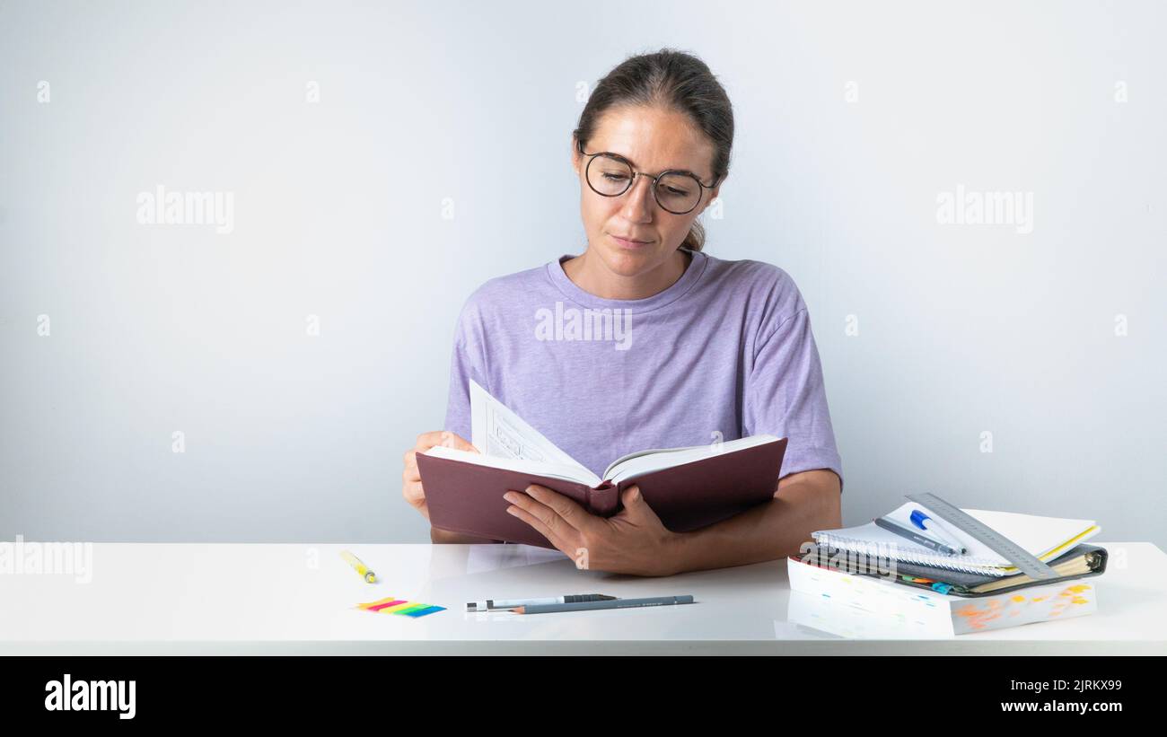 Student turns the page of a book or textbook. High quality photo Stock Photo