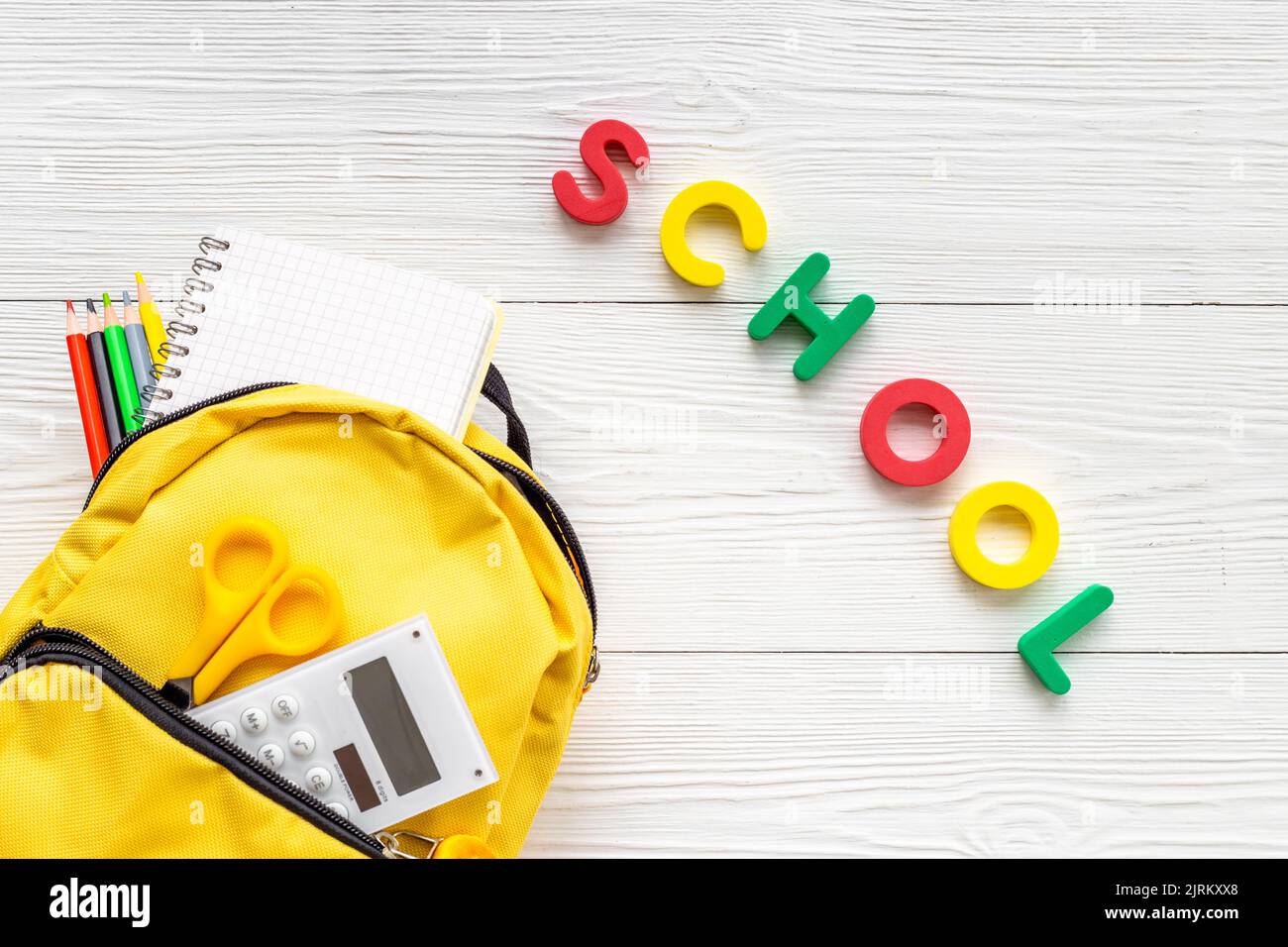School backpack with school items and students equipment, top view Stock Photo