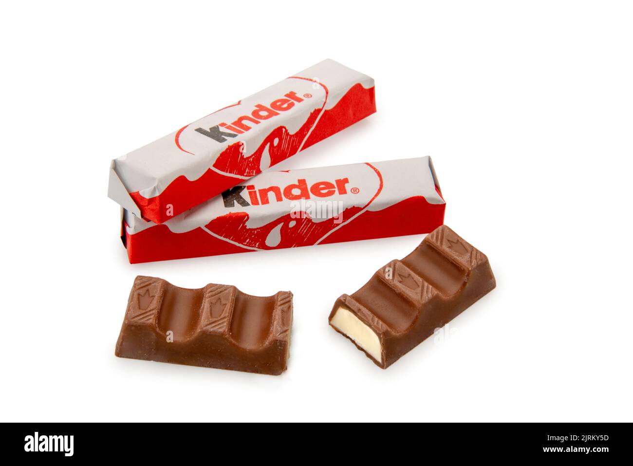 Alba, Italy - August 19, 2022: Kinder Ferrero Chocolate bar with milk heart, wrapped bars and one cut, isolated on white, clipping path Stock Photo