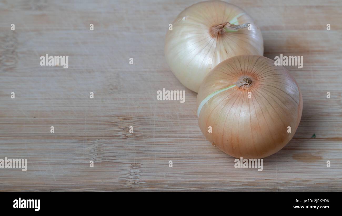 Onions in husks on a wooden board vegetables background. High quality photo Stock Photo