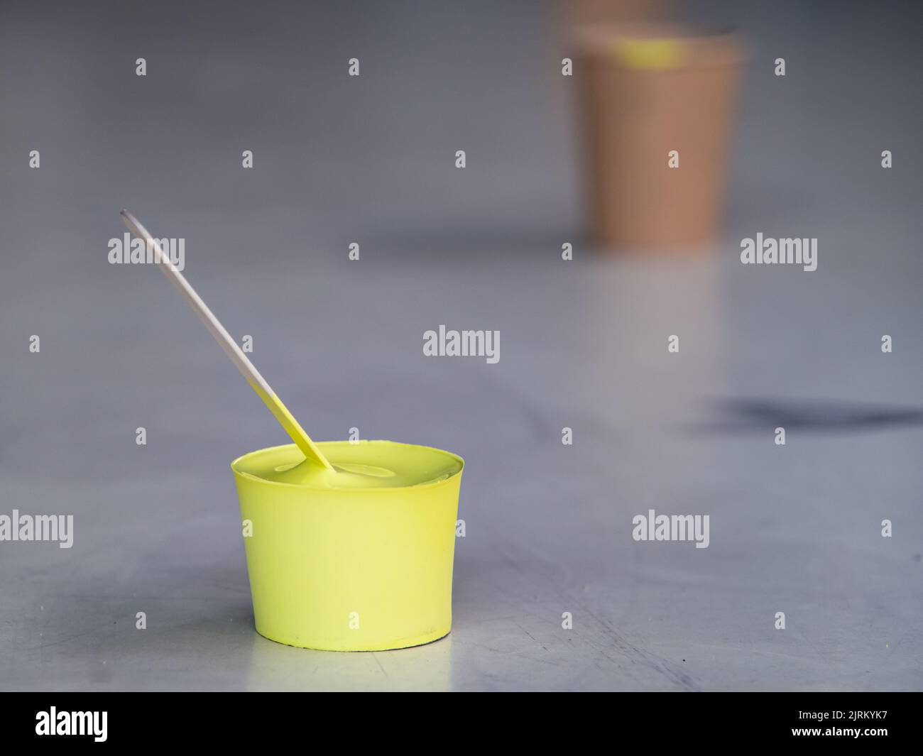 Yellow paint that has dried in the container and taken shape like a mold Stock Photo