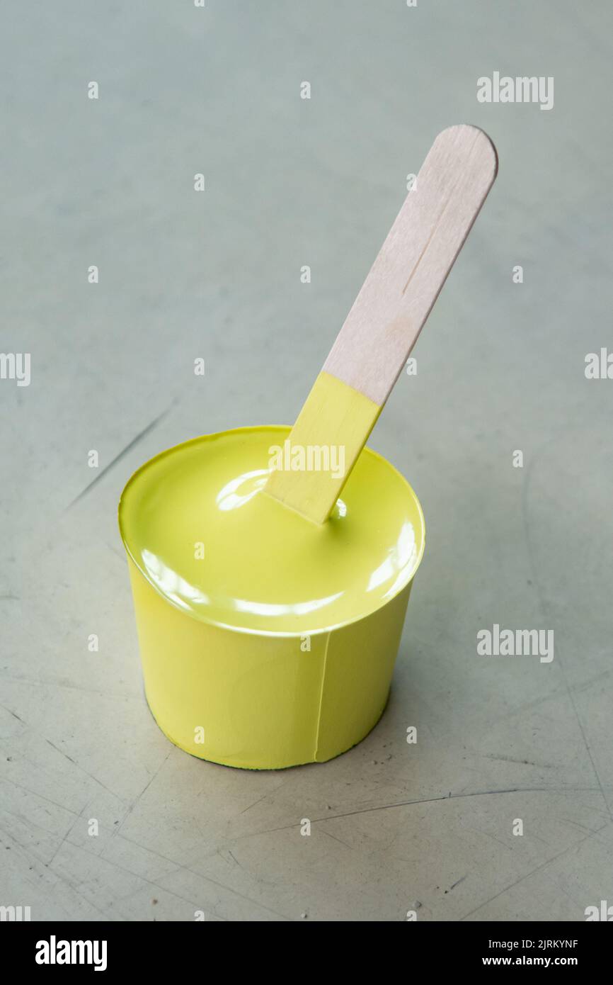 Yellow paint that has dried in the container and taken shape like a mold Stock Photo