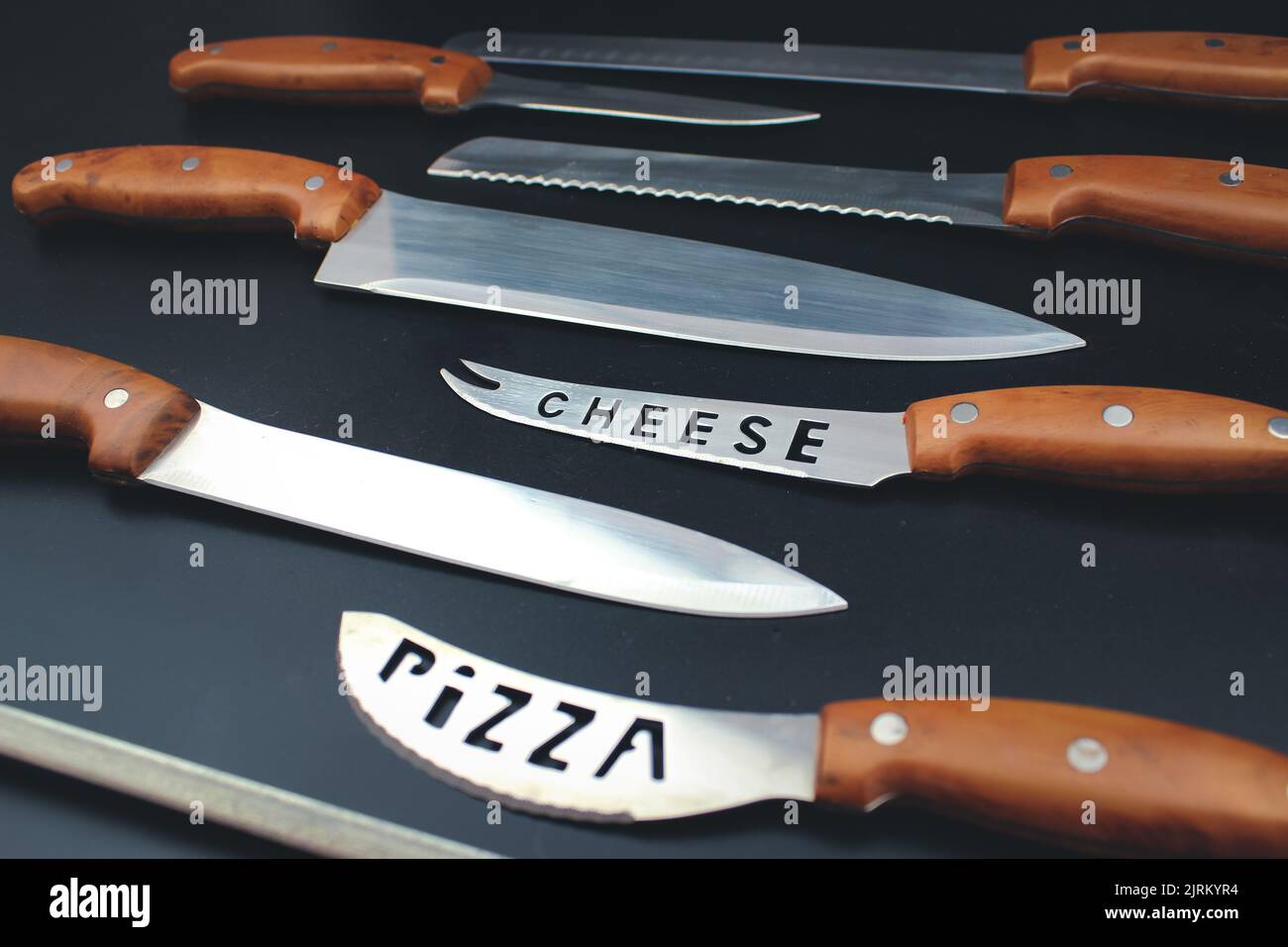 Set of kitchen knives with wooden handle, top view, close up. Stock Photo