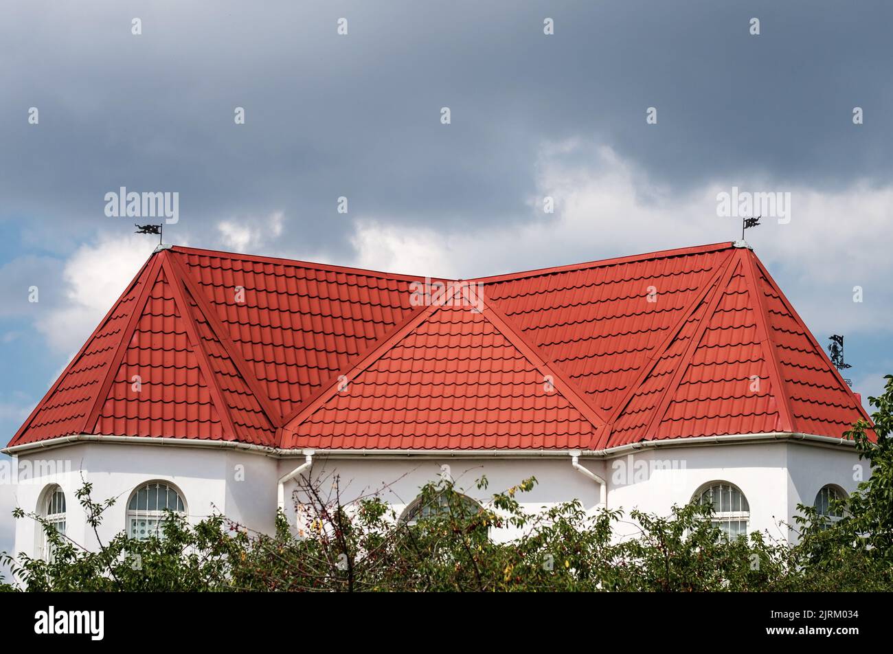 Roof made of light brown red metal tile, metal roofing shingles against blue sky Stock Photo Alamy