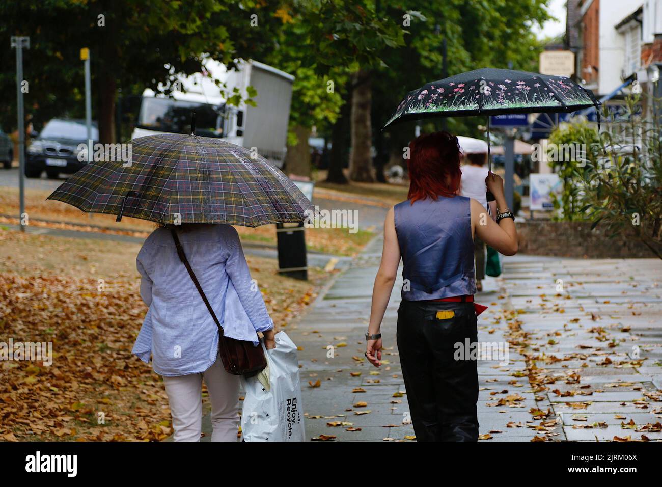 Tenterden, Kent, UK. 25 Aug, 2022. UK Weather: Heavy rain and thunder expected to roll into the South East. Colourful umbrellas as Tenterden town is hit by rain. Photo Credit: Paul Lawrenson /Alamy Live News Stock Photo