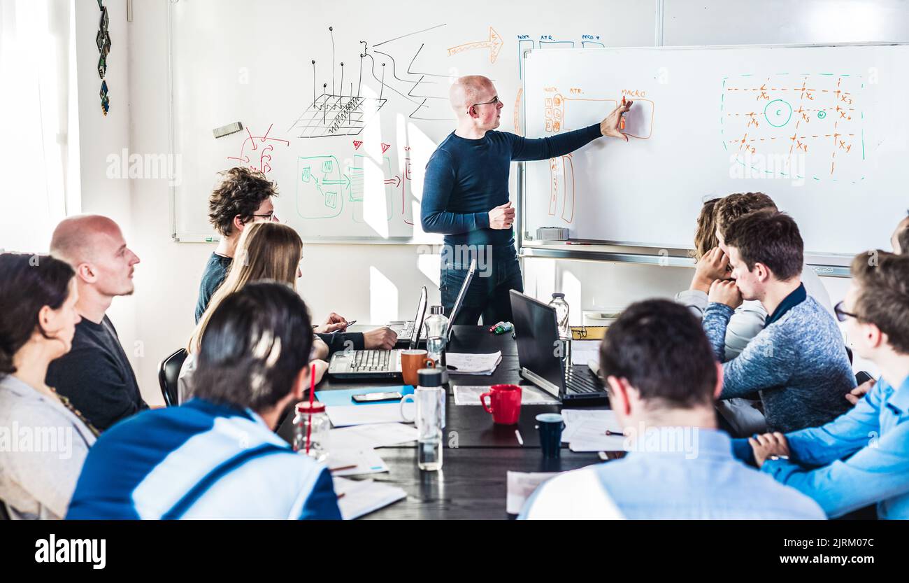 Informal IT business startup company meeting. Team leader discussing and brainstorming new project and ideas with colleagues. Startup business and Stock Photo