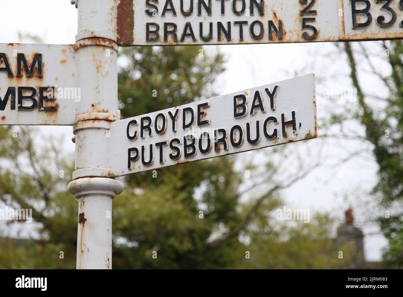 Old iron sign post for Croyde Bay and Putsborough, Croyde village, Braunton, North Devon, England, UK, August 2022 Stock Photo