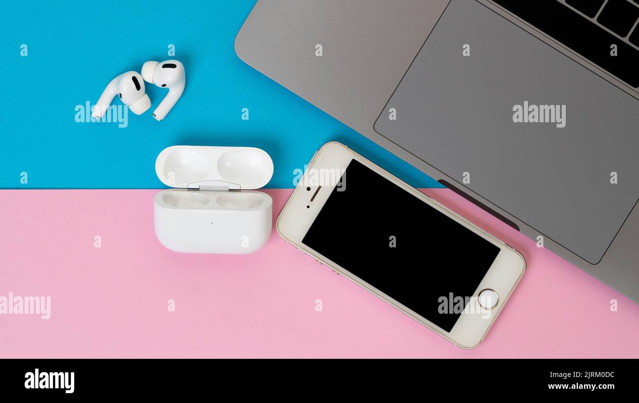 Laptop, phone and wireless headphones on a two-tone background Stock ...