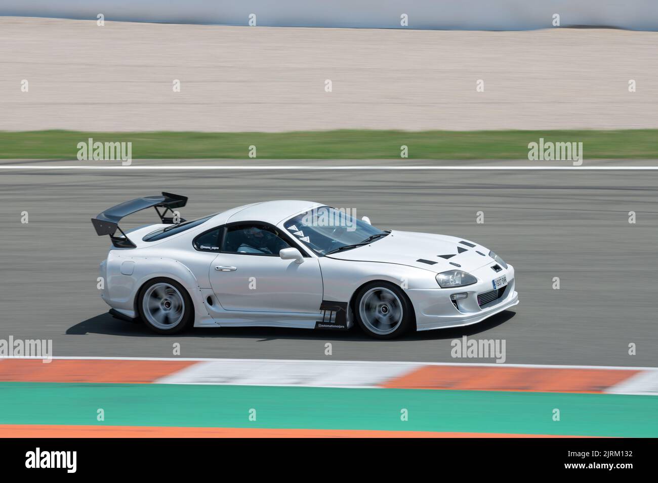 A closeup shot of a white fourth-generation Toyota Supra Japanese sports car racing on the race track Stock Photo