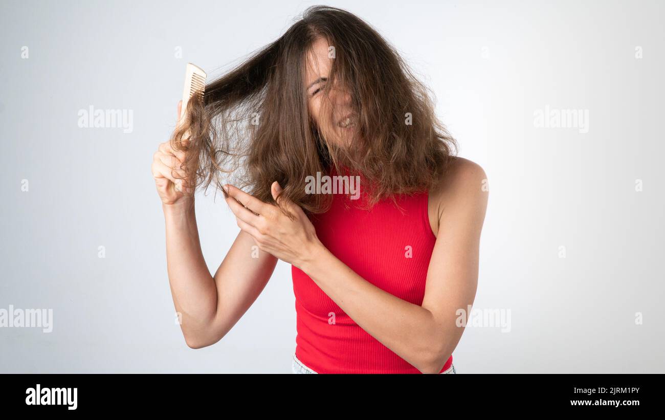 It hurts a woman when combing naughty, tangled hair pulling out a