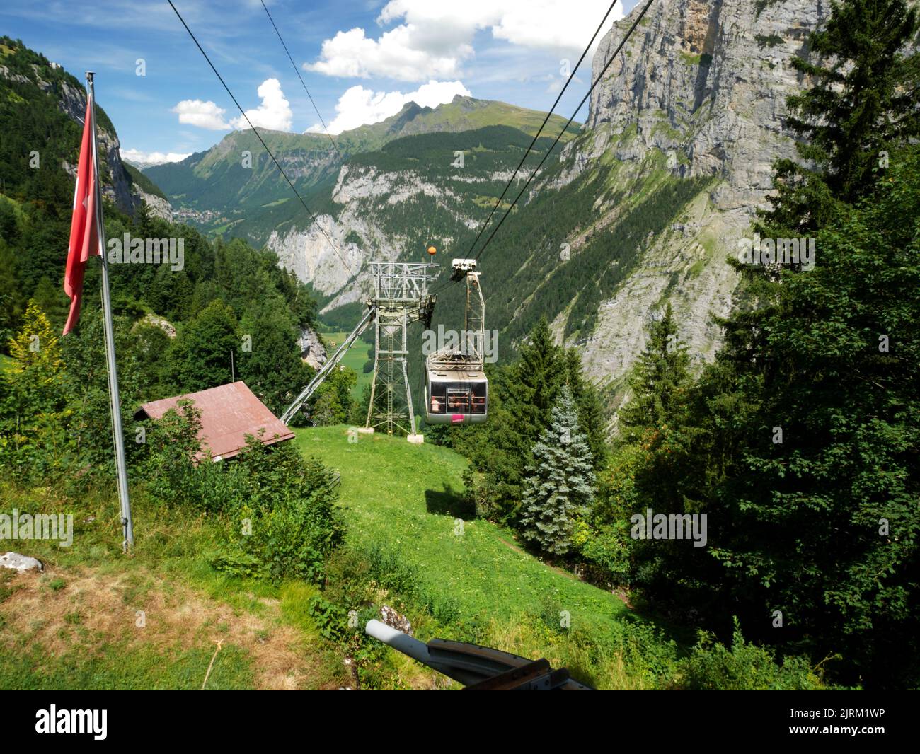A cable car from Stechelberg approaches Gimmelwald, Murren, Bernese Oberland, Switzerland. Stock Photo