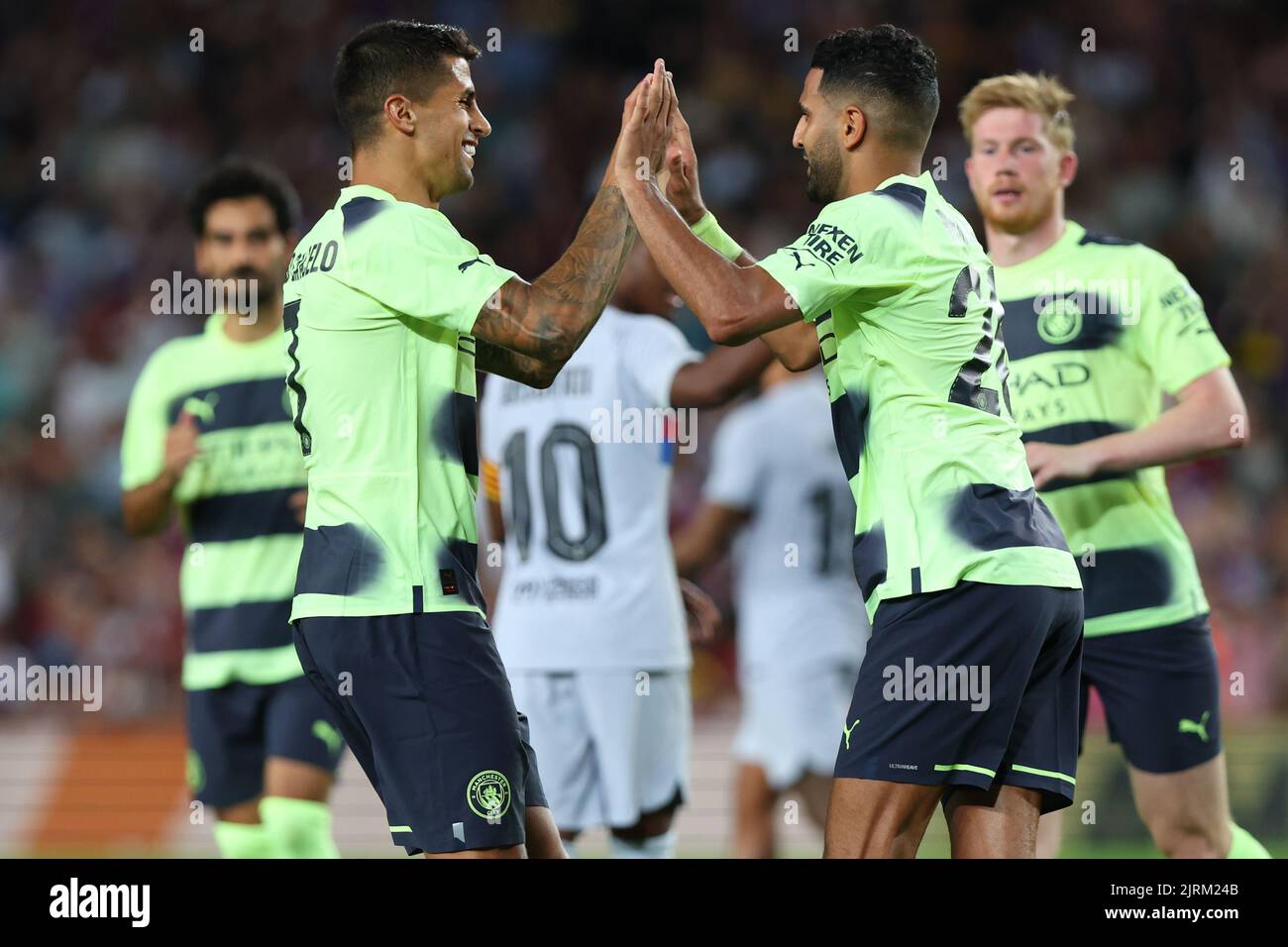 Barcelona, Spain. 24th Aug, 2022. Riyad Mahrez of Manchester City celebrate a goal with Joao Cancelo of Manchester City during the benefic friendly match to raise funds for ELA between FC Barcelona and Manchester City at Spotify Camp Nou in Barcelona, Spain. Credit: DAX Images/Alamy Live News Stock Photo