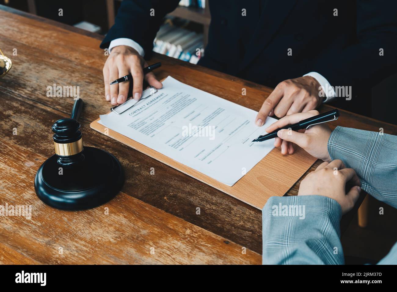 business people and lawyers discussing contract papers sitting at the