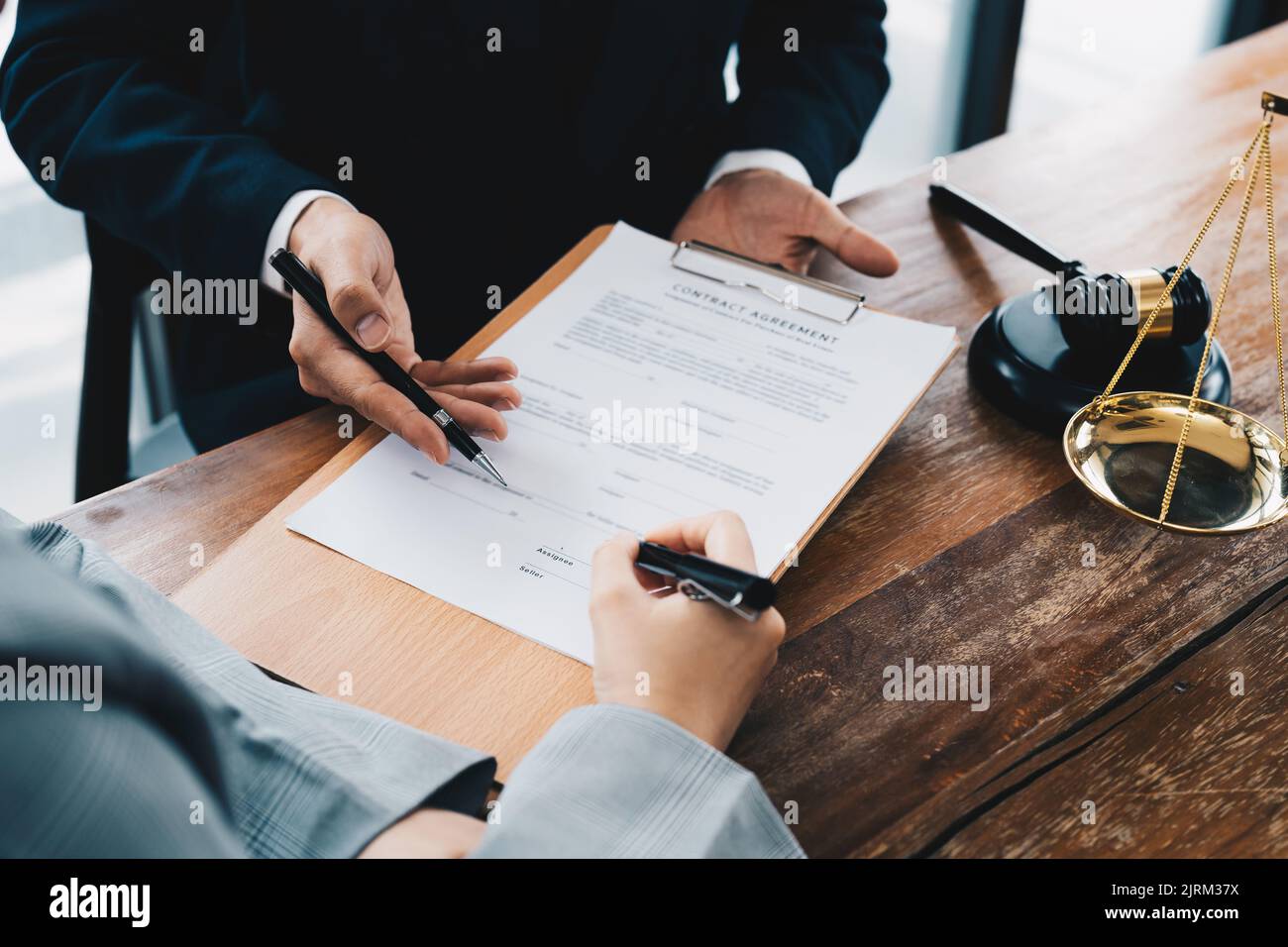 business people and lawyers discussing contract papers sitting at the table. Concepts of law, advice, legal services. Stock Photo