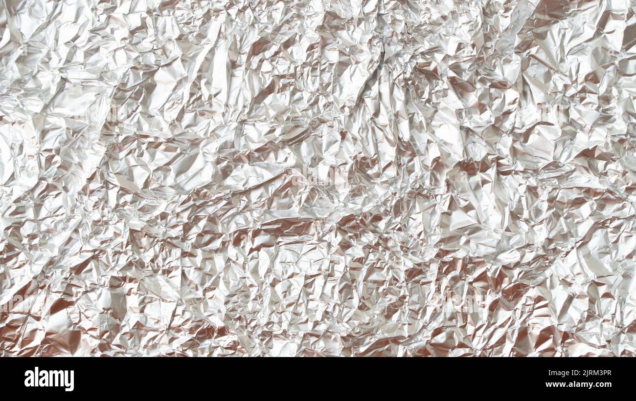 Rumpled foil texture background silver Stock Photo - Alamy