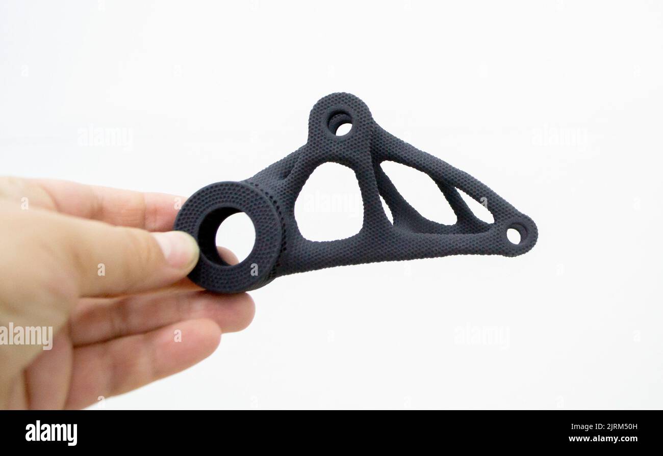 Person holding plastic model printed on powder 3d printer from powder ...