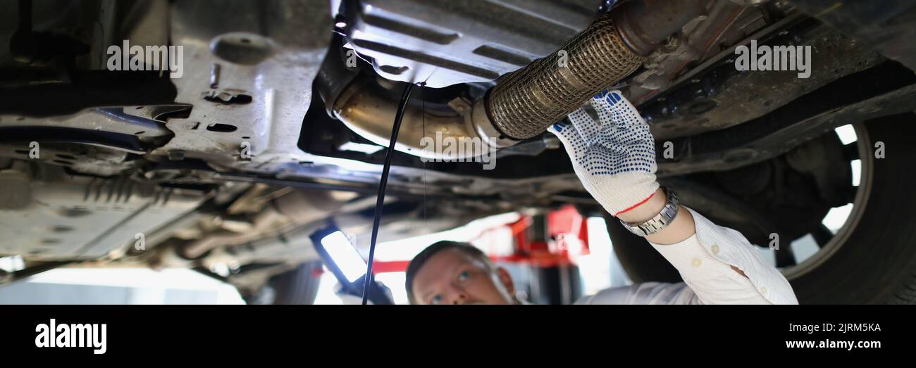Man repairman fixing car in workshop closeup Stock Photo